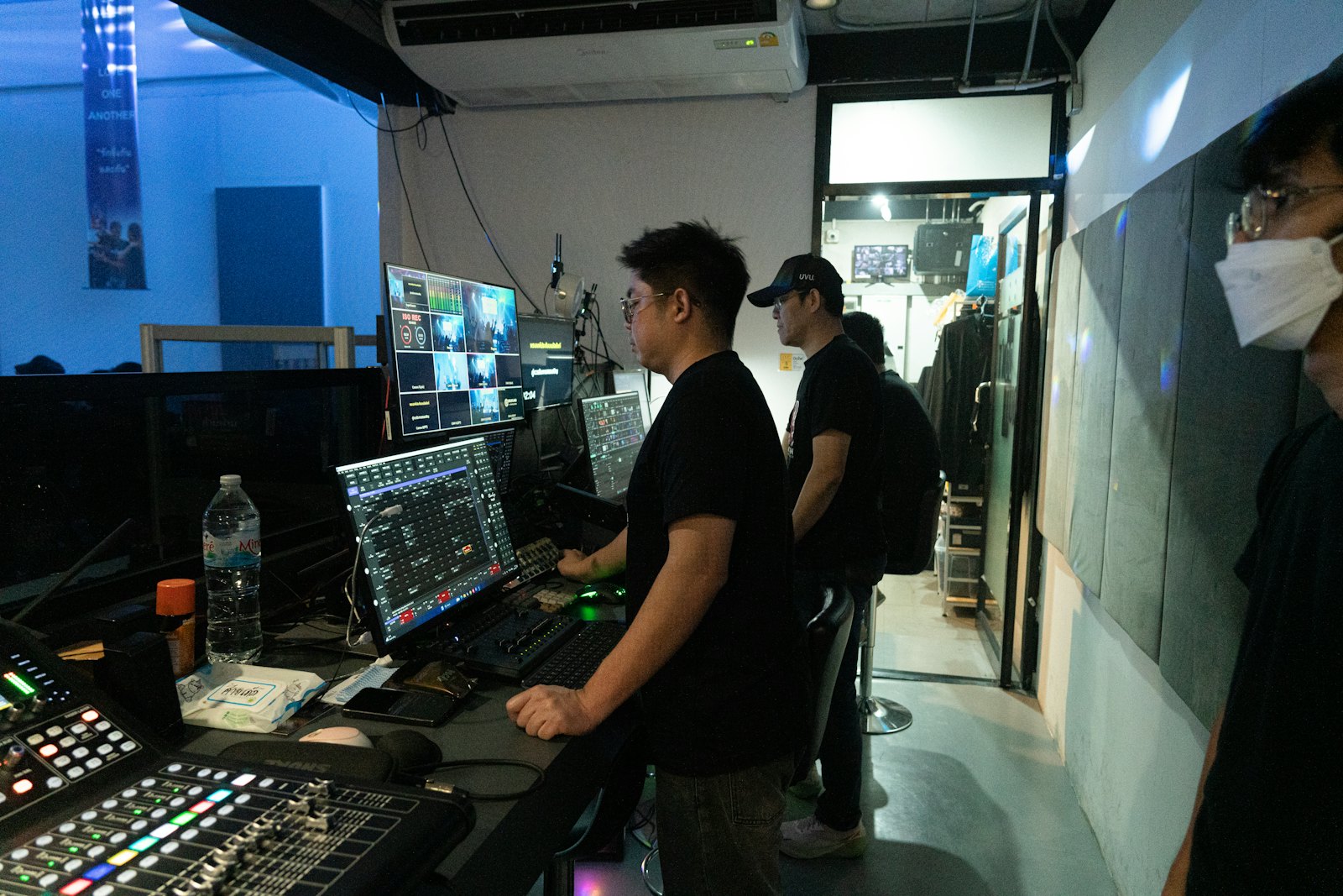 Operators at a broadcast control desk with multiview monitors